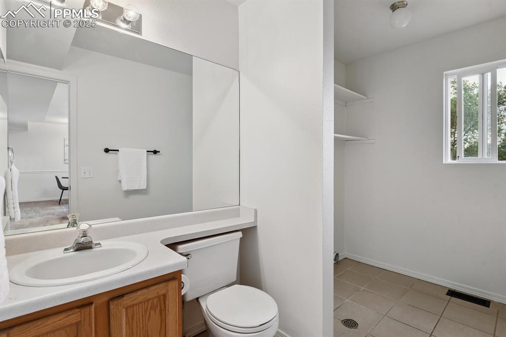 Image 16 of 45: Bathroom featuring vanity and tile patterned flooring