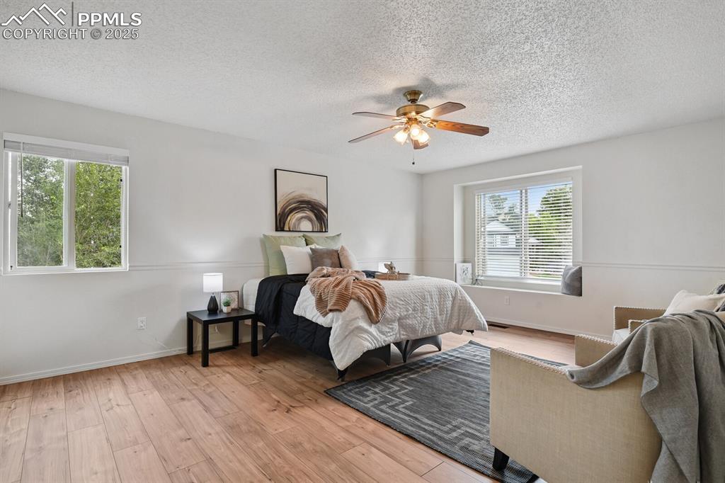 Image 17 of 45: Bedroom featuring light wood-style flooring, a textured ceiling, and ceilin
