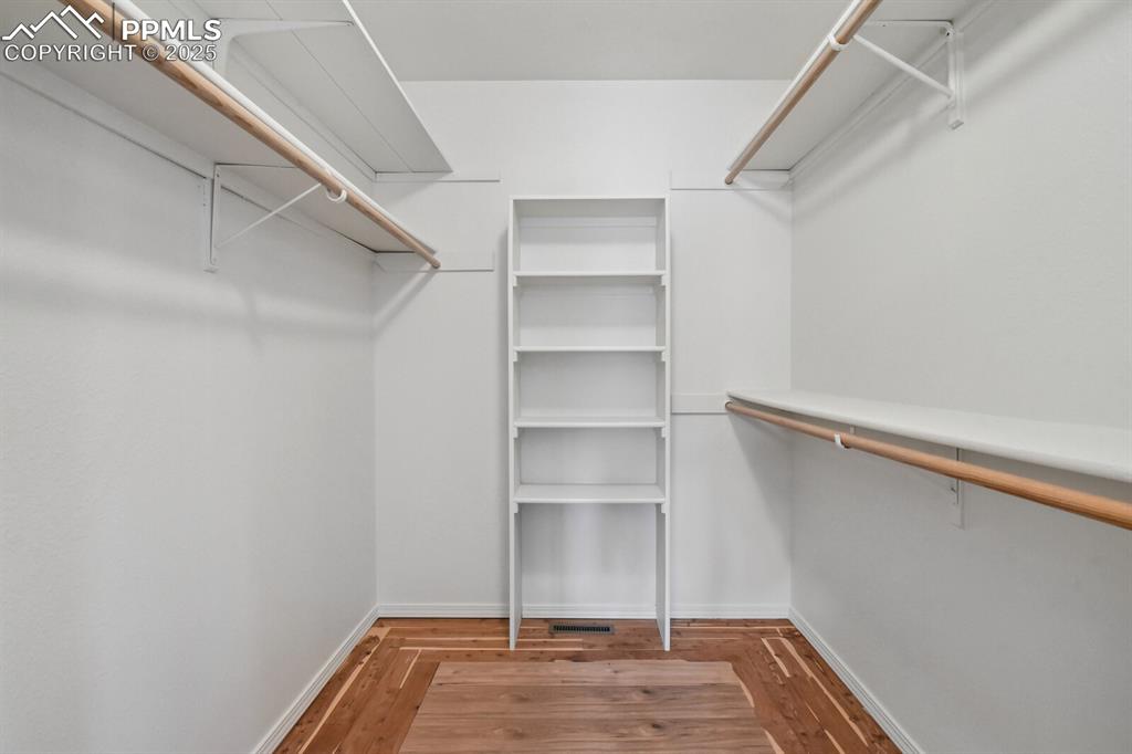 Image 21 of 45: Walk in closet featuring wood finished floors