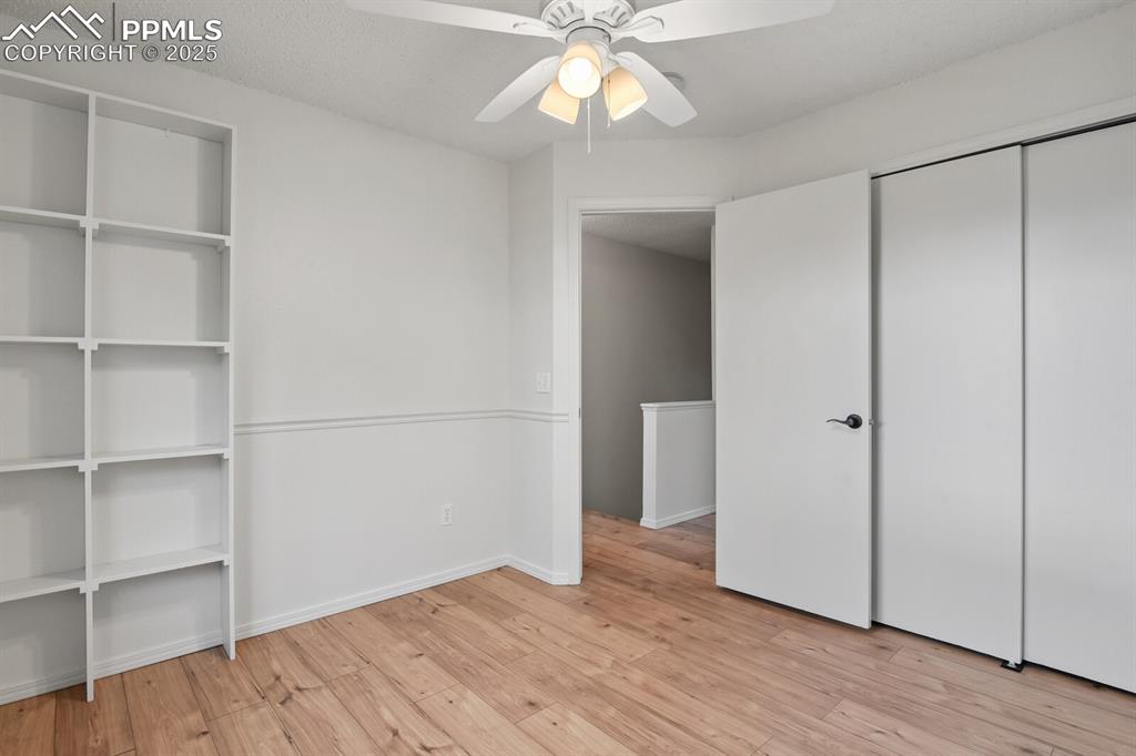 Image 23 of 45: Unfurnished bedroom featuring light wood-style floors and a ceiling fan
