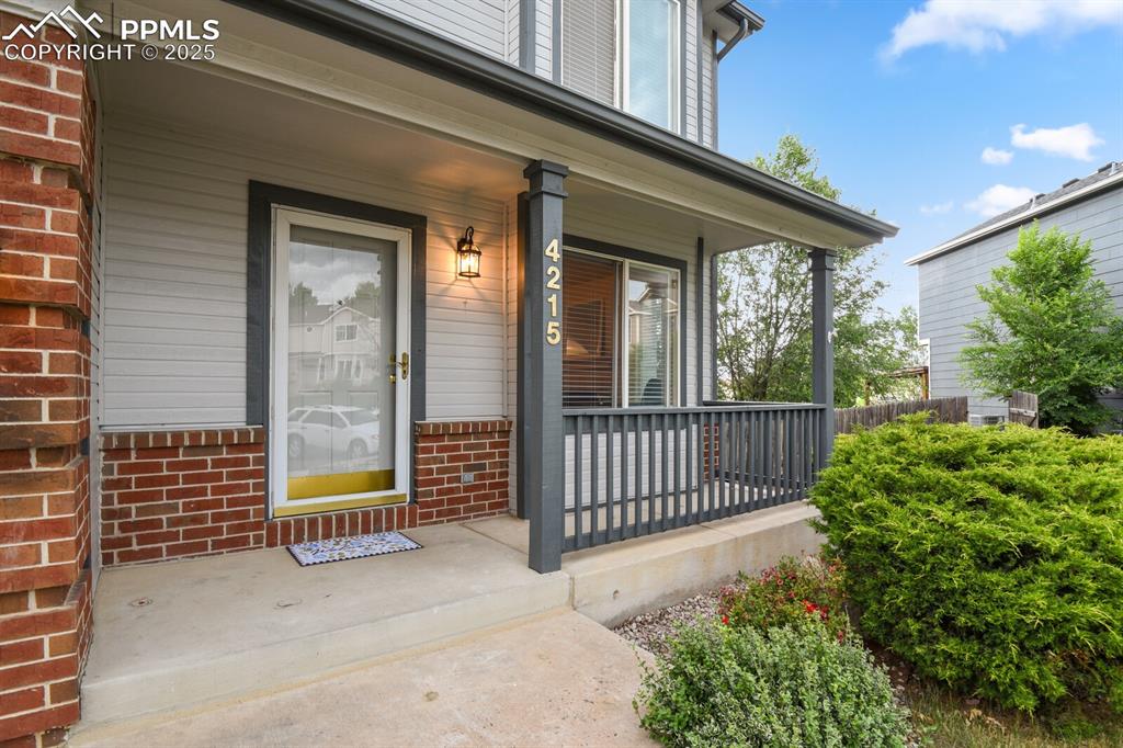Image 3 of 45: Entrance to property with covered porch and brick siding