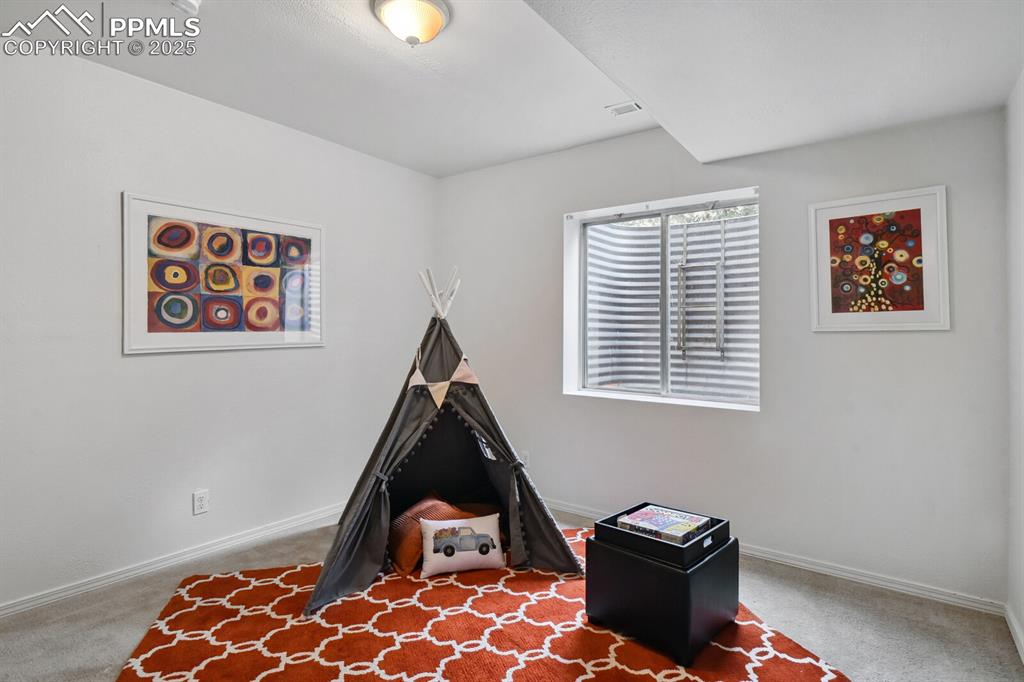 Image 32 of 45: Game room featuring carpet flooring and baseboards