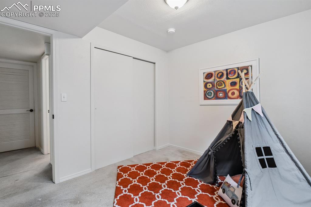 Image 33 of 45: Recreation room with carpet and baseboards
