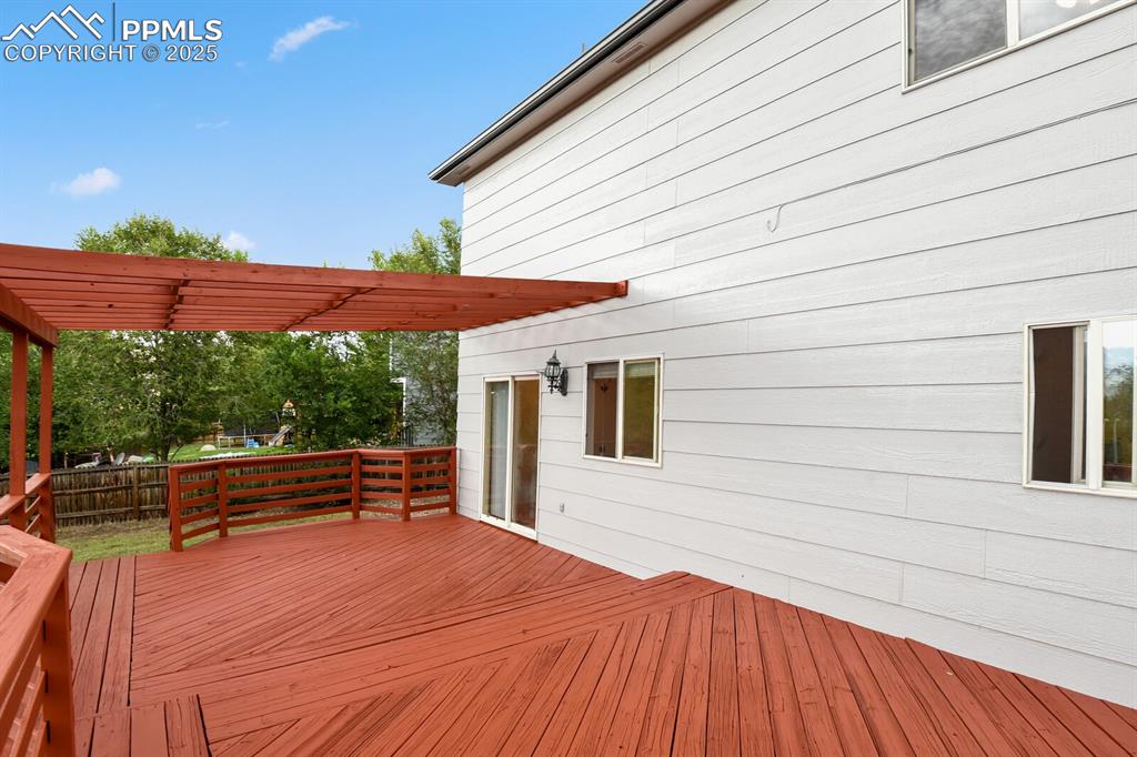 Image 37 of 45: Deck featuring a fenced backyard, a storage shed, a mountain view, and a pe