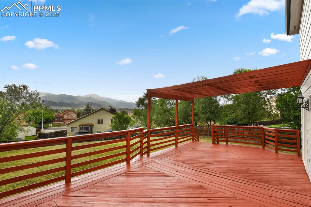 Image 39 of 45: Rear view of property with a deck, a pergola, and roof with shingles