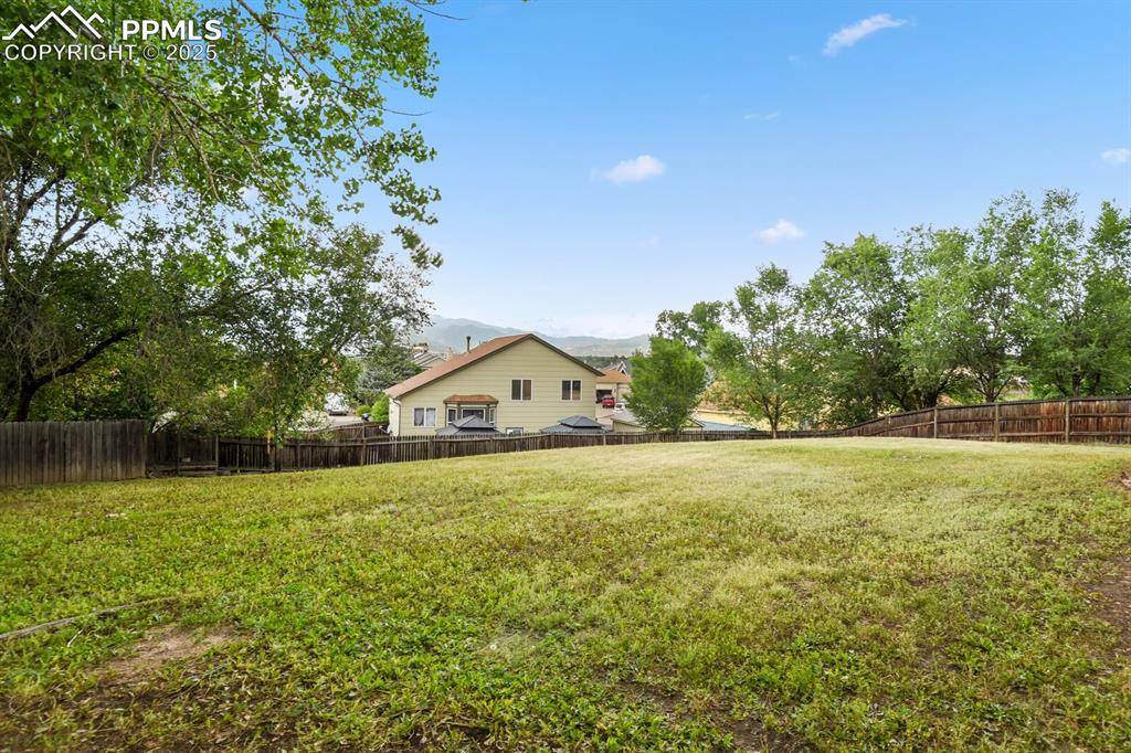 Image 41 of 45: View of yard featuring a storage shed and a deck with mountain view