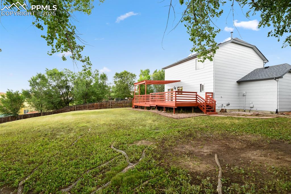 Image 43 of 45: View of yard with a deck with mountain view and a pergola