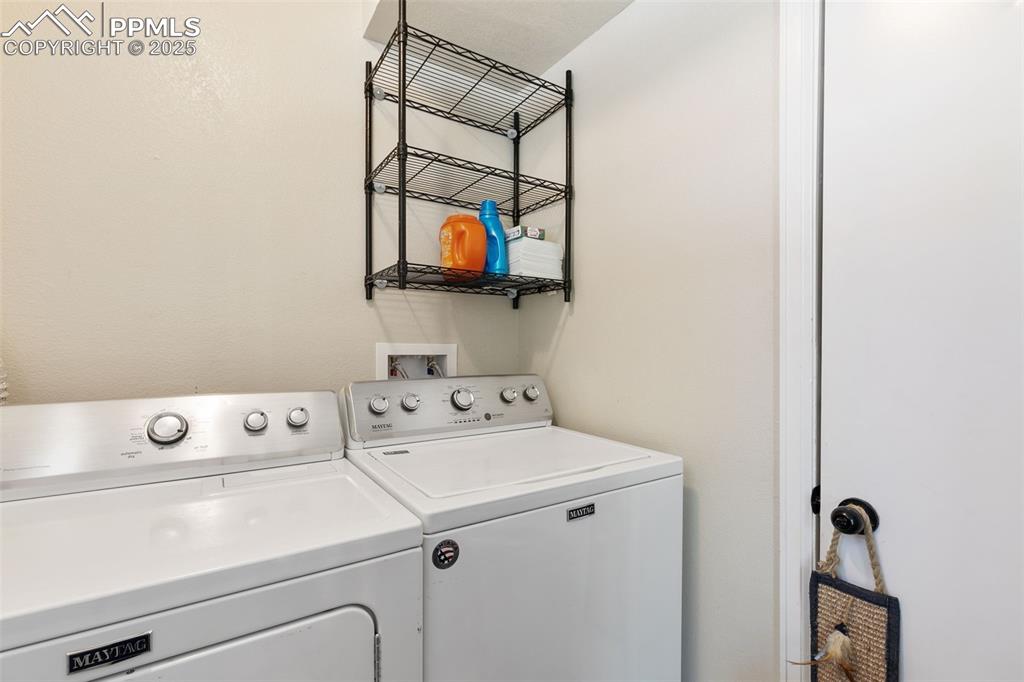 Image 21 of 29: Laundry room featuring washing machine and clothes dryer