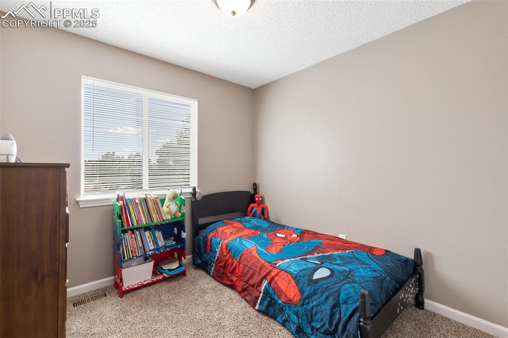 Image 29 of 29: Bedroom featuring carpet floors and a textured ceiling