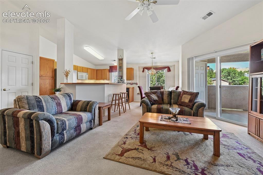 Image 4 of 48: living room with walk-out to covered patio