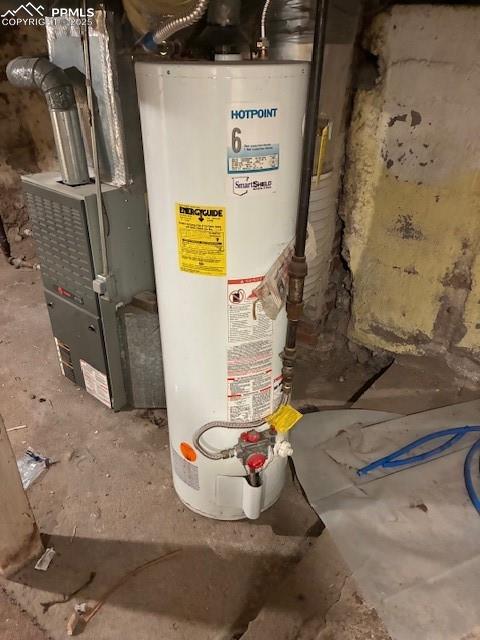 Image 12 of 13: Utility room featuring gas water heater and heating unit
