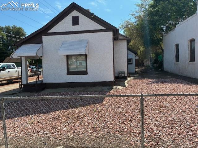 Image 3 of 13: View of side of property featuring stucco siding