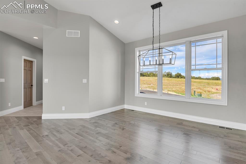 Image 14 of 44: Dining area w/great view.  Door on the right is the pantry