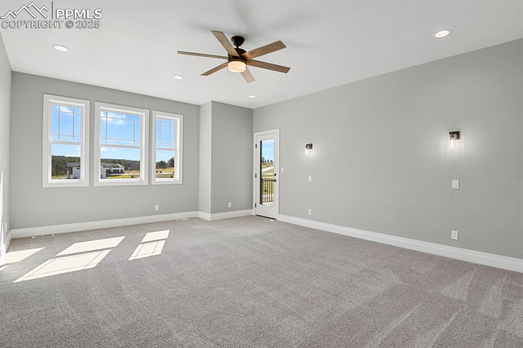 Image 15 of 44: Primary bedroom w/access to deck