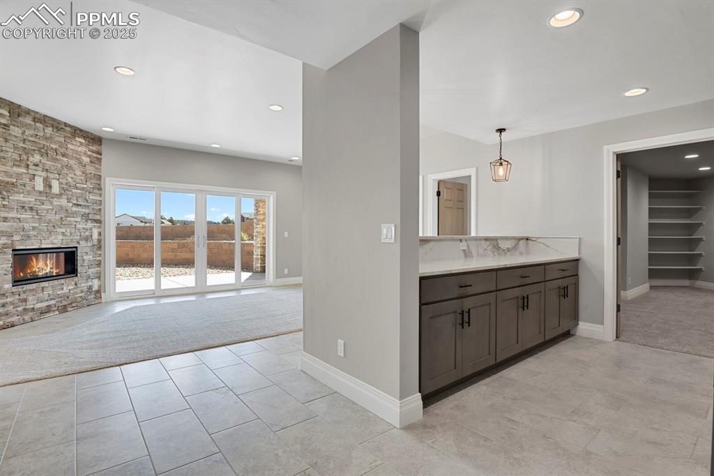 Image 28 of 44: family room - bar view, access to theater room on the right