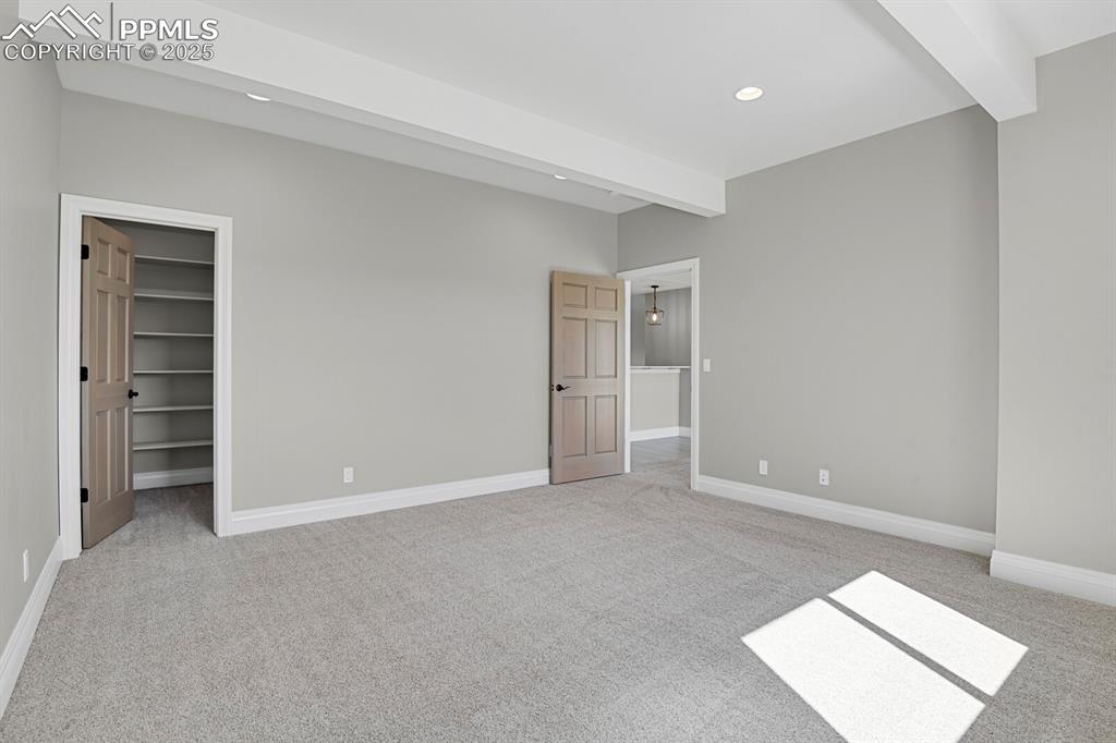 Image 32 of 44: Bedroom #3 view of walk-in closet with built-in shelves
