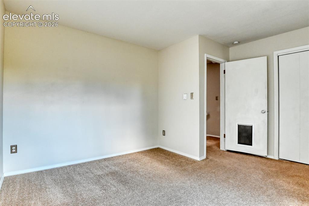 Image 24 of 50: Wall-to-wall carpeting with light-toned walls and white trim