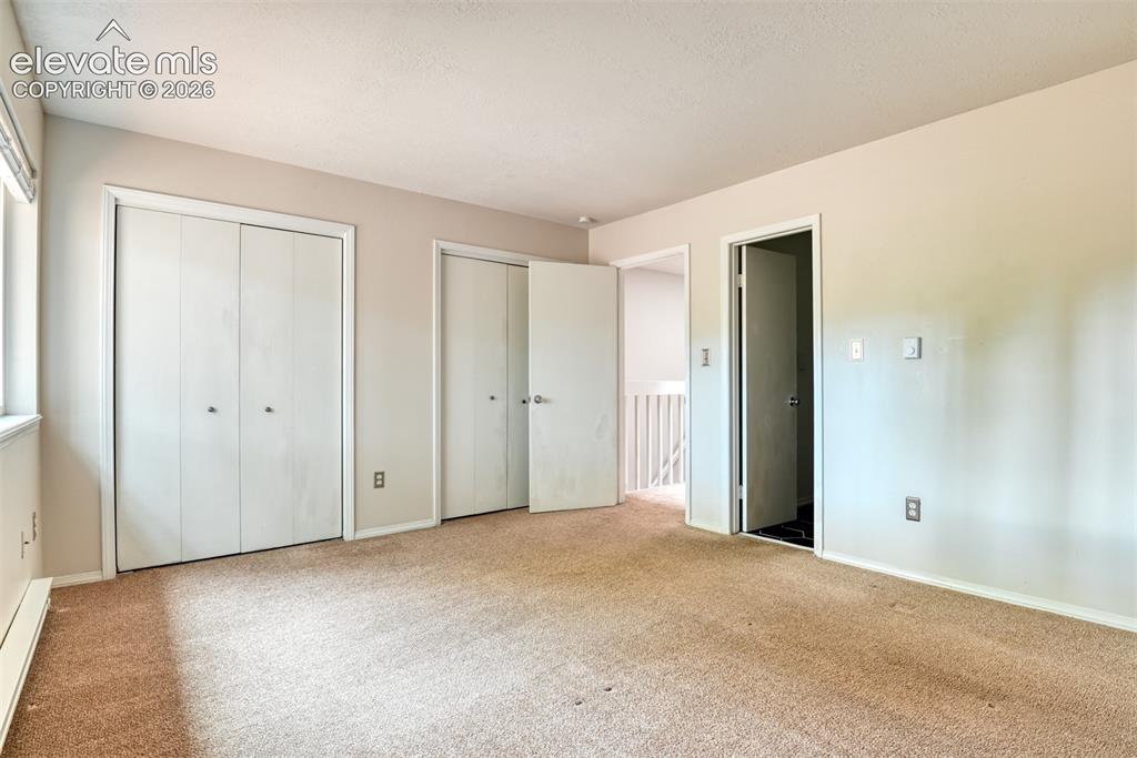 Image 31 of 50: Wall-to-wall carpeting with light-toned walls, white trim, and a window