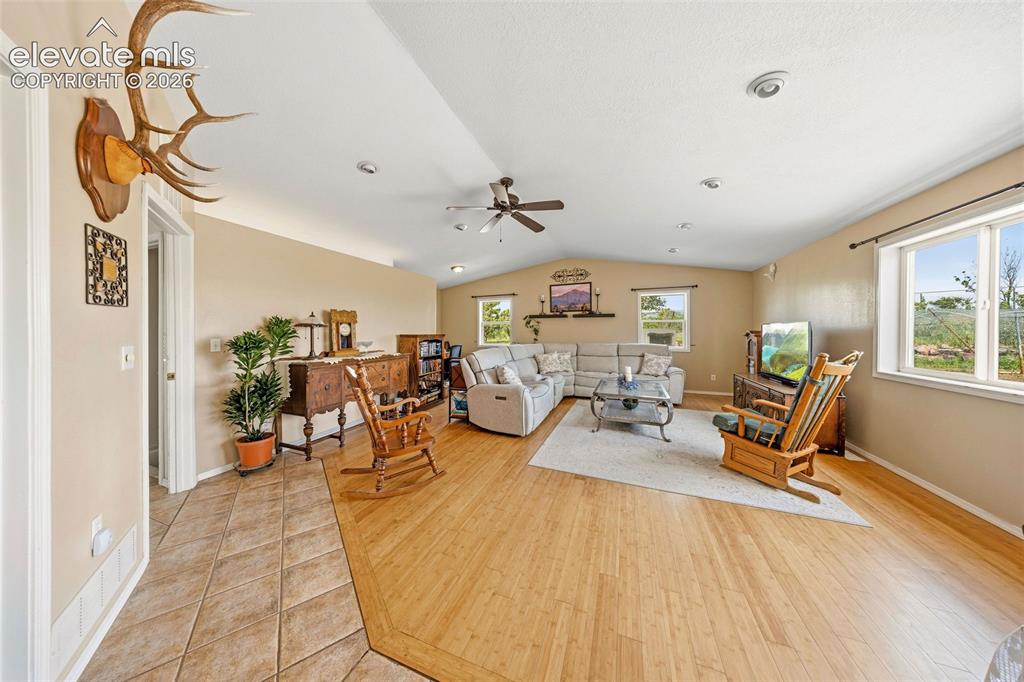 Image 12 of 40: Family room as is featuring spacious living area, wood-finish flooring, rec