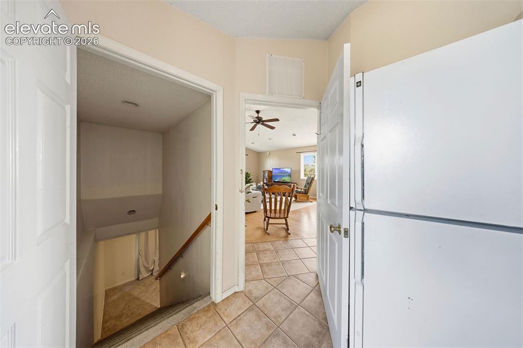 Image 23 of 40: Entrance to basement featuring oversized stairs for easy moving.