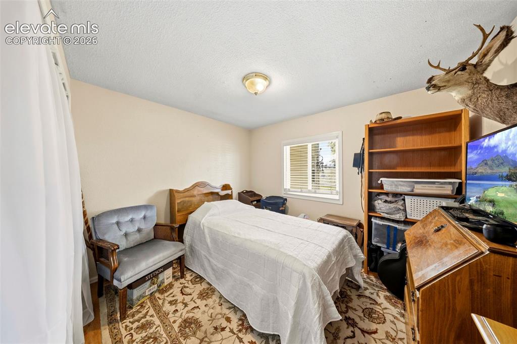 Image 24 of 40: One of four main floor bedrooms or office space.