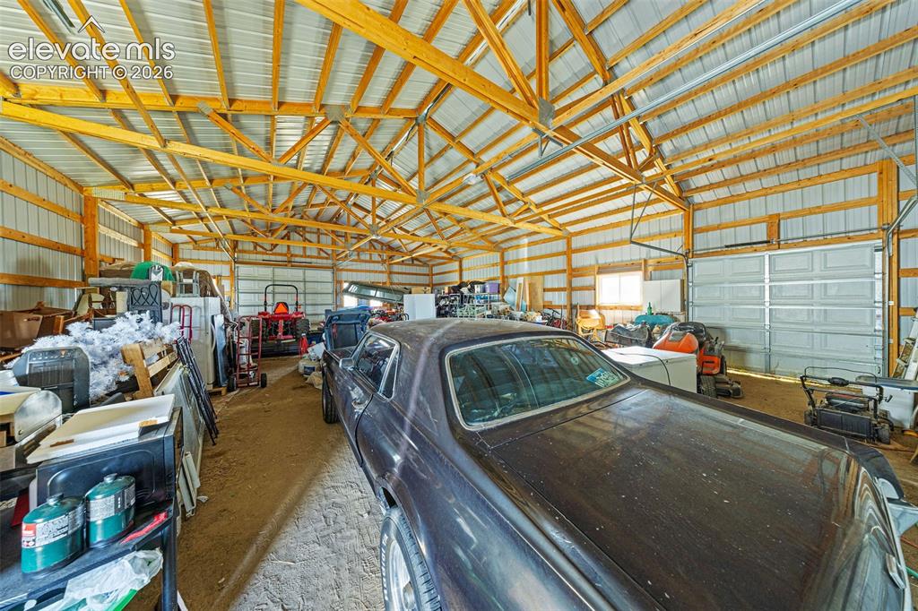 Image 31 of 40: Inside of spacious barn outbuilding featuring a high-pitched roof with expo