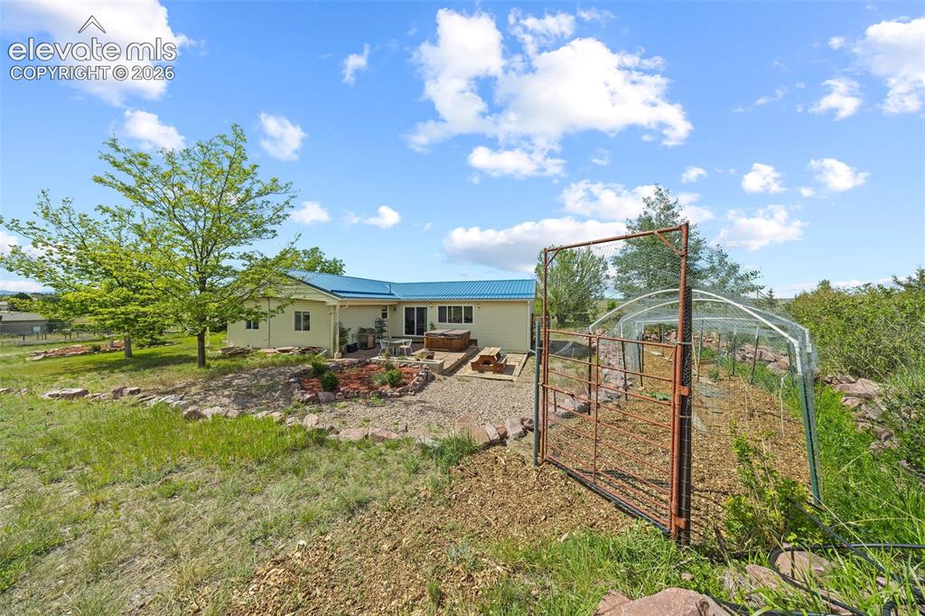 Image 36 of 40: Rear exterior featuring sliding glass doors to backyard.