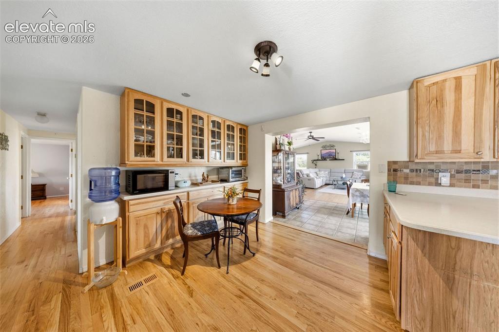 Image 9 of 40: Breakfast nook with build-in custom cabinets and counters.
