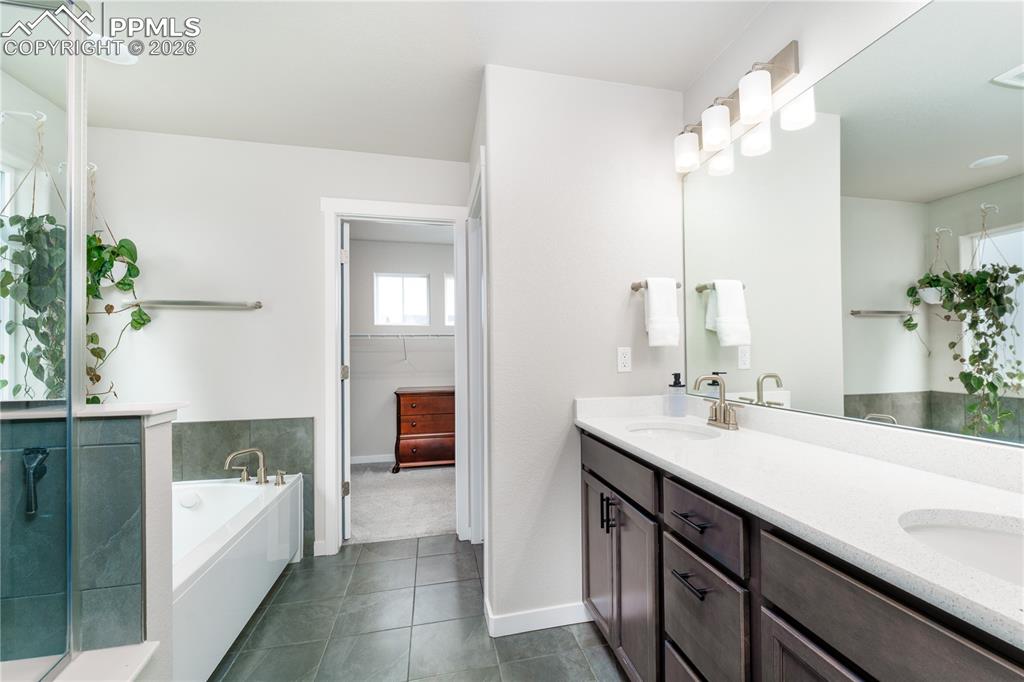 Image 16 of 38: primary suite 5 piece bathroom with walk in closet