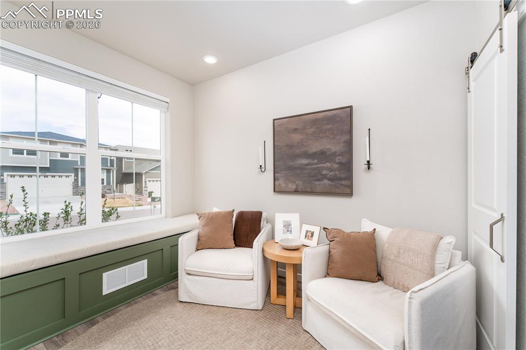 Image 4 of 38: Front sitting room with pocket office