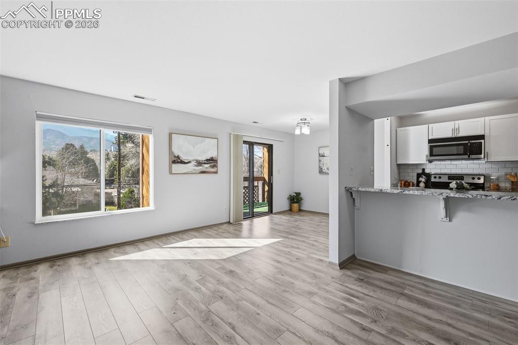 Image 6 of 26: view towards dining room and kitchen