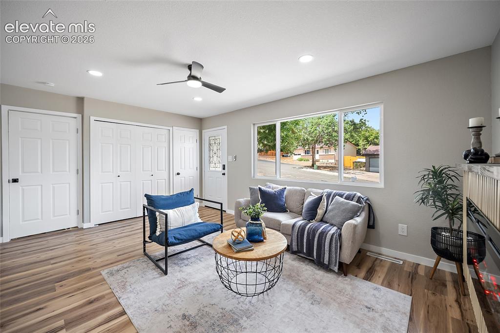 Image 13 of 49: Wood-finish flooring, recessed lighting, and a modern ceiling fan