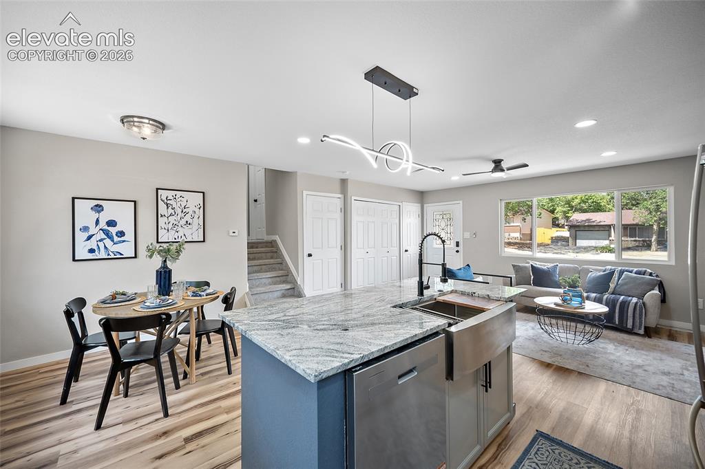 Image 18 of 49: Open-concept living area featuring wood-finish flooring, a kitchen island w