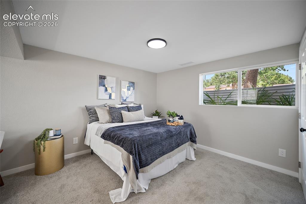 Image 32 of 49: Carpeted flooring, recessed lighting, double-paned window, and a built-in w