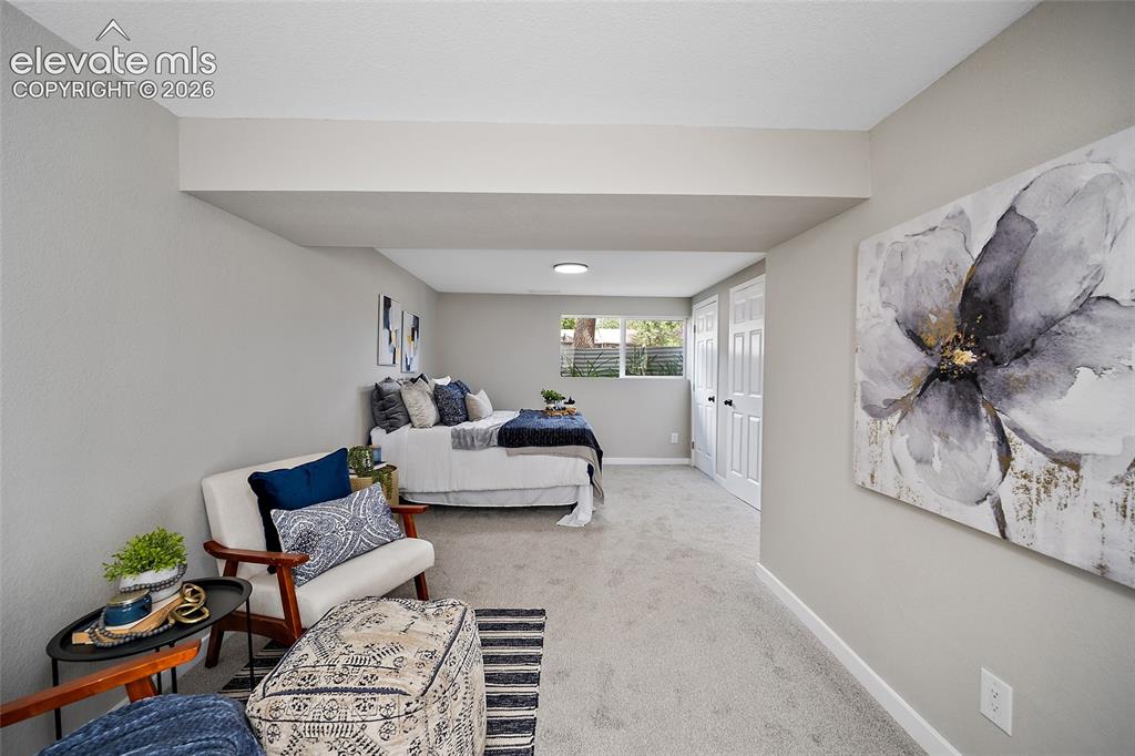 Image 36 of 49: Recessed ceiling beam, light-colored carpeting, white baseboards, window wi