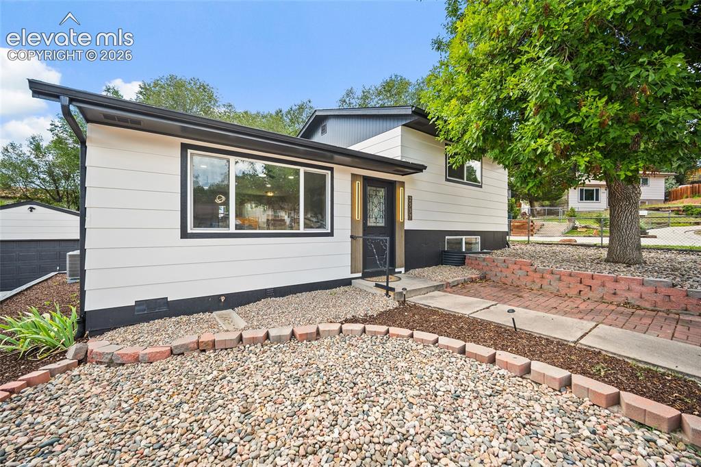 Image 4 of 49: Contemporary exterior with light siding and dark trim
