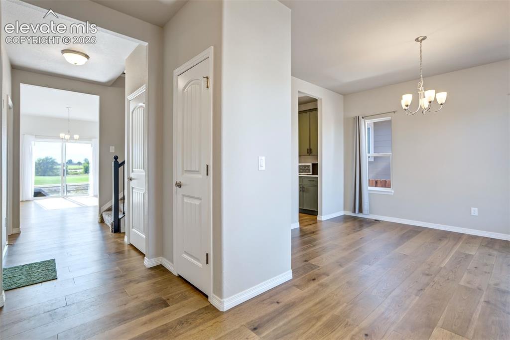 Image 12 of 47: Wood-finish flooring throughout, white trim, and light gray wall color