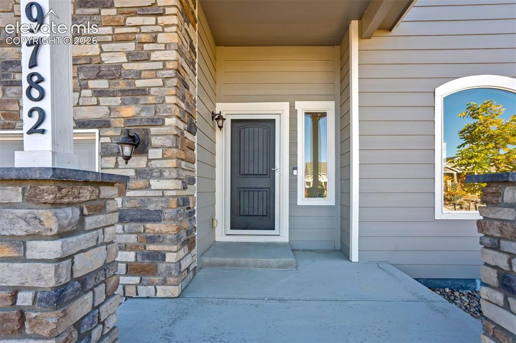 Image 2 of 47: Stone veneer accents and siding exterior
