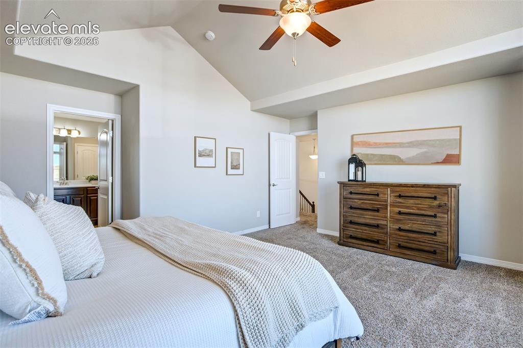Image 22 of 47: Vaulted ceiling, ceiling fan with integrated lighting, carpeted flooring, a