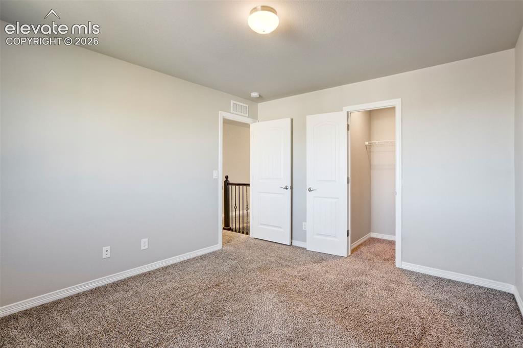 Image 29 of 47: Neutral-toned walls, plush carpet flooring, recessed lighting, and a built-