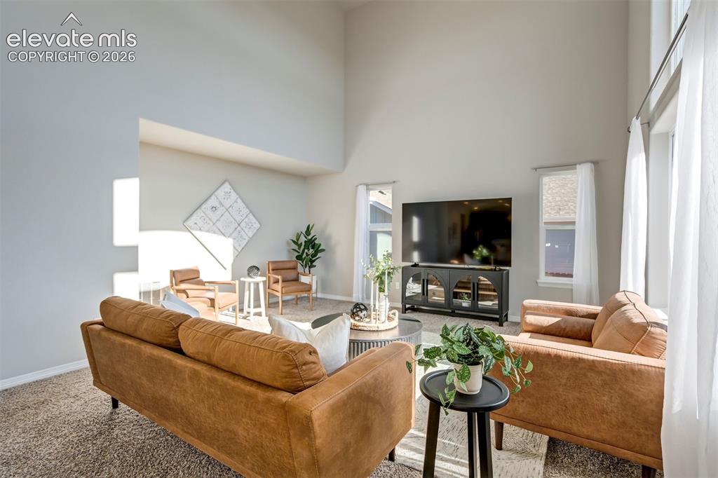 Image 3 of 47: Vaulted ceilings, expansive windows, recessed lighting, and soft gray wall