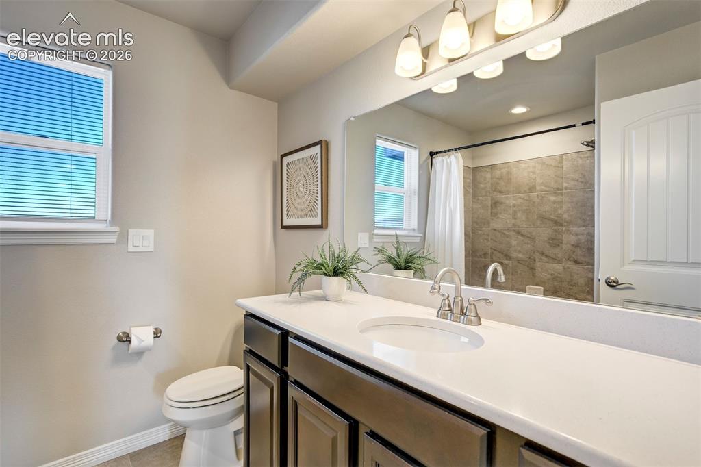 Image 30 of 47: Bathroom featuring a single vanity with a white countertop, an undermount s