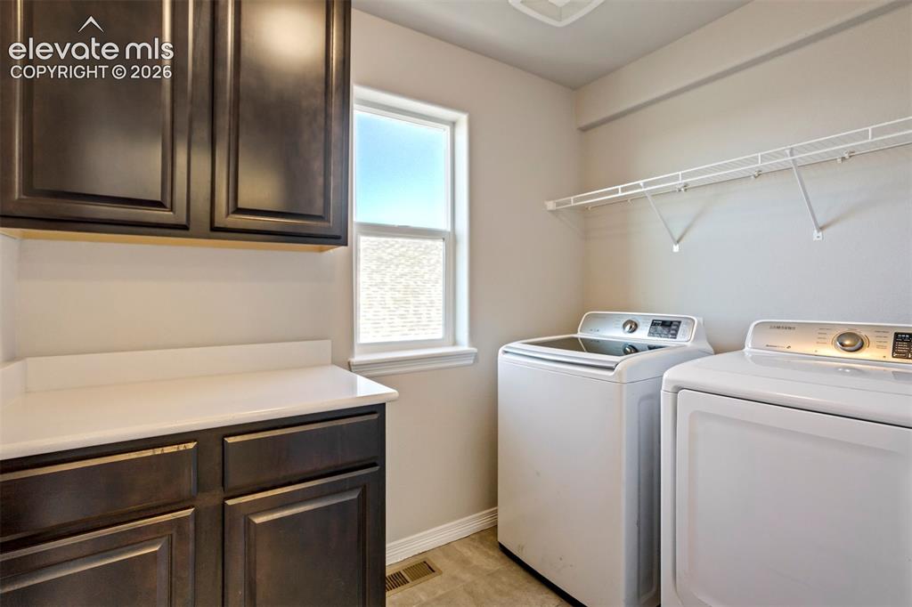 Image 33 of 47: Utility room featuring dark wood-finish cabinetry, a white countertop, a wi