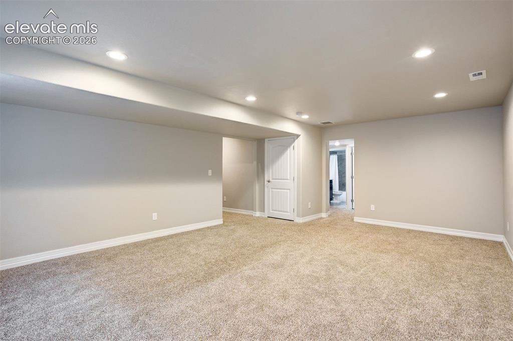 Image 35 of 47: Open floor plan with plush carpeting, recessed lighting, and a neutral colo