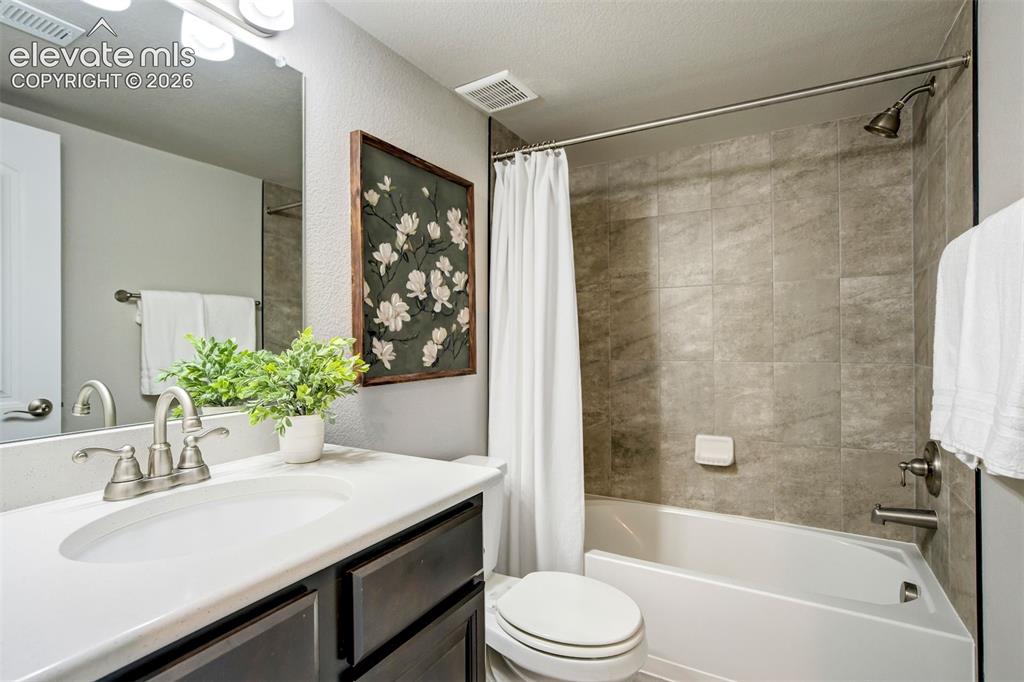 Image 37 of 47: Vanity with an integrated sink, brushed nickel faucet, and dark wood-finish