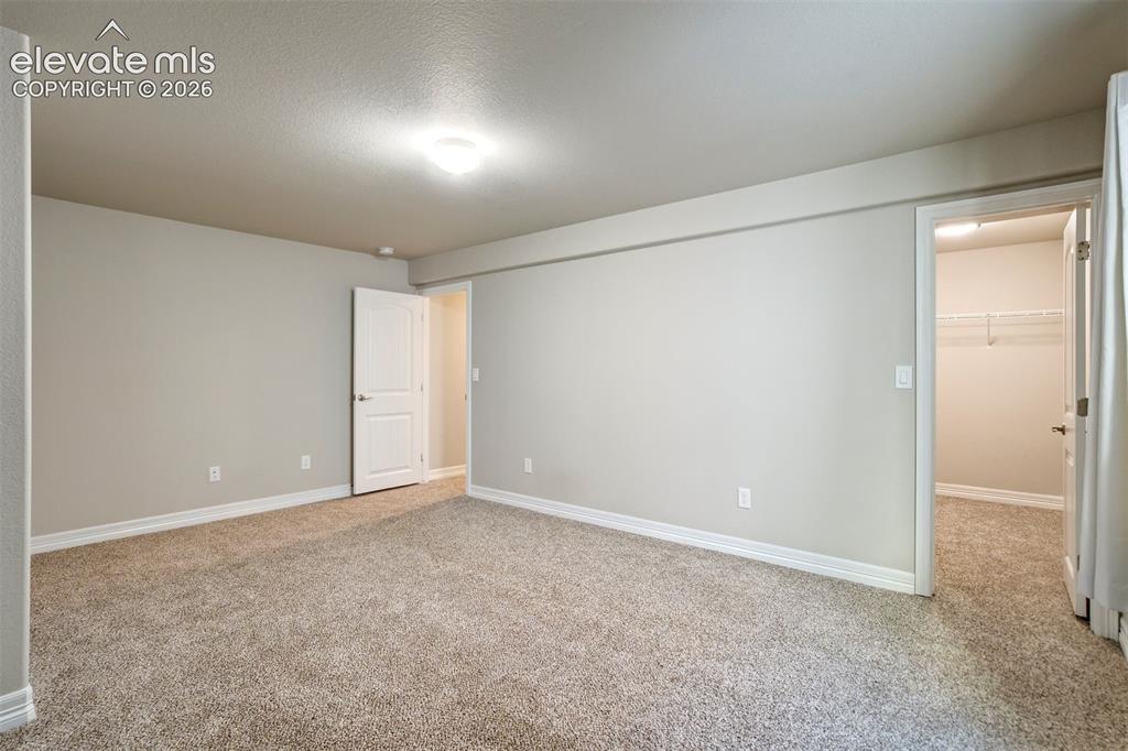 Image 40 of 47: Neutral wall paint, plush carpet flooring, recessed lighting, and a walk-in