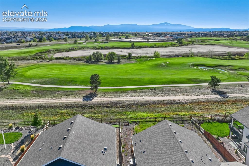 Image 45 of 47: Expansive golf course frontage with established trees, distant mountain ran