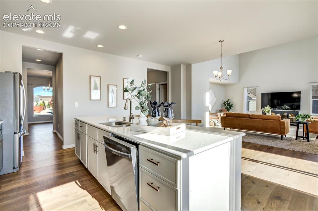 Image 6 of 47: Kitchen island with a stainless steel sink, a pull-down faucet, and an inte