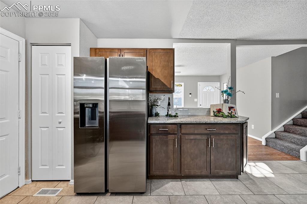 Image 13 of 46: A pantry next to the side by side refrigerator. This kitchen will be a grea