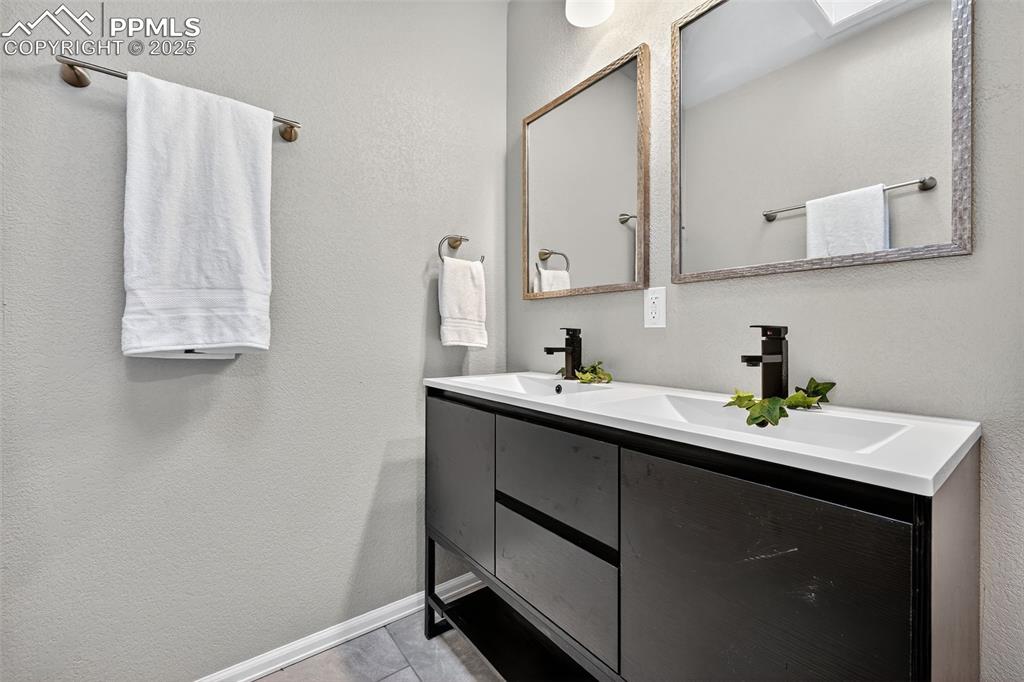 Image 19 of 46: The double vanity in the master bathroom. 
